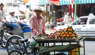 Ein Fruchtverkäufer im alltäglichen Getümmel.##Foto: flickr.com flydime Ein Fruchtverkäufer im alltäglichen Getümmel.