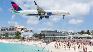 Urlauber beobachten im März 2016 am Maho Beach auf dem niederlaendischen Teil der Insel St. Martin ein landendes Flugzeug der Fluggesellschaft Delta Urlauber beobachten im März 2016 am Maho Beach auf dem niederlaendischen Teil der Insel St. Martin ein landendes Flugzeug der Fluggesellschaft Delta