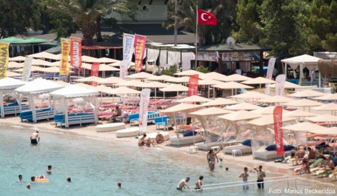 Ein Mann mit einem Besen geht an einem leeren Strand in Antalya entlang. Die Bundesregierung hat die Reisewarnung für die Türkei teilweise aufgehoben
